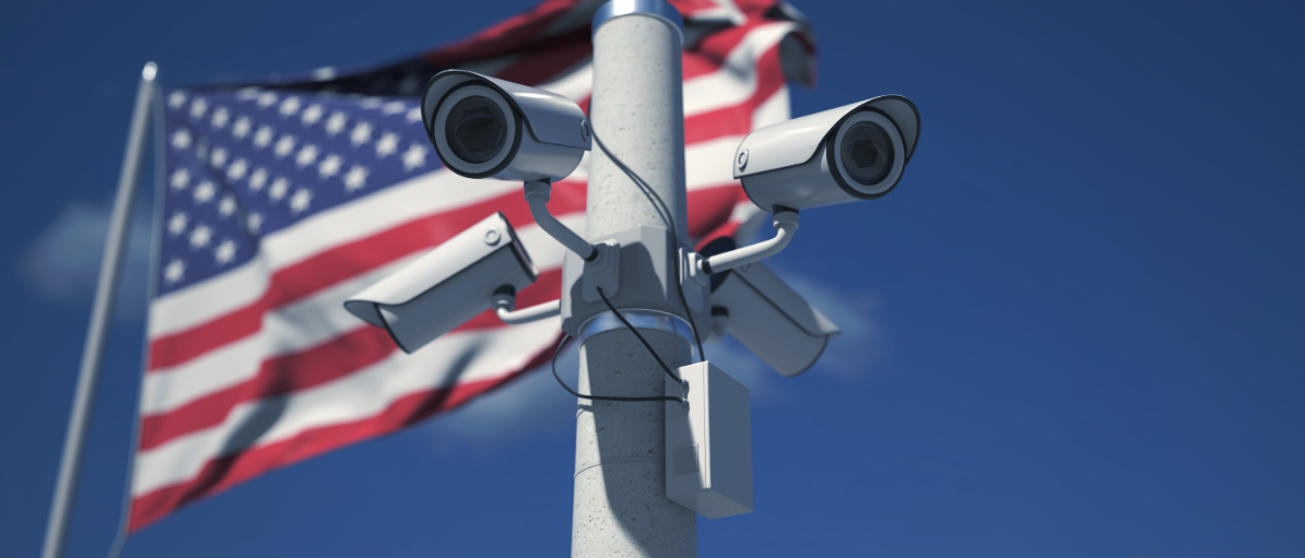 security camera on a poll with American flag in background