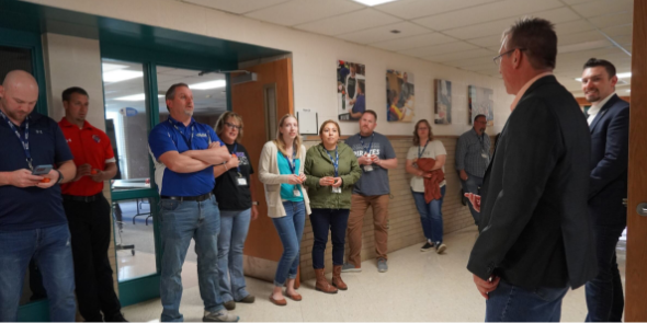 picture of team members standing and learning together